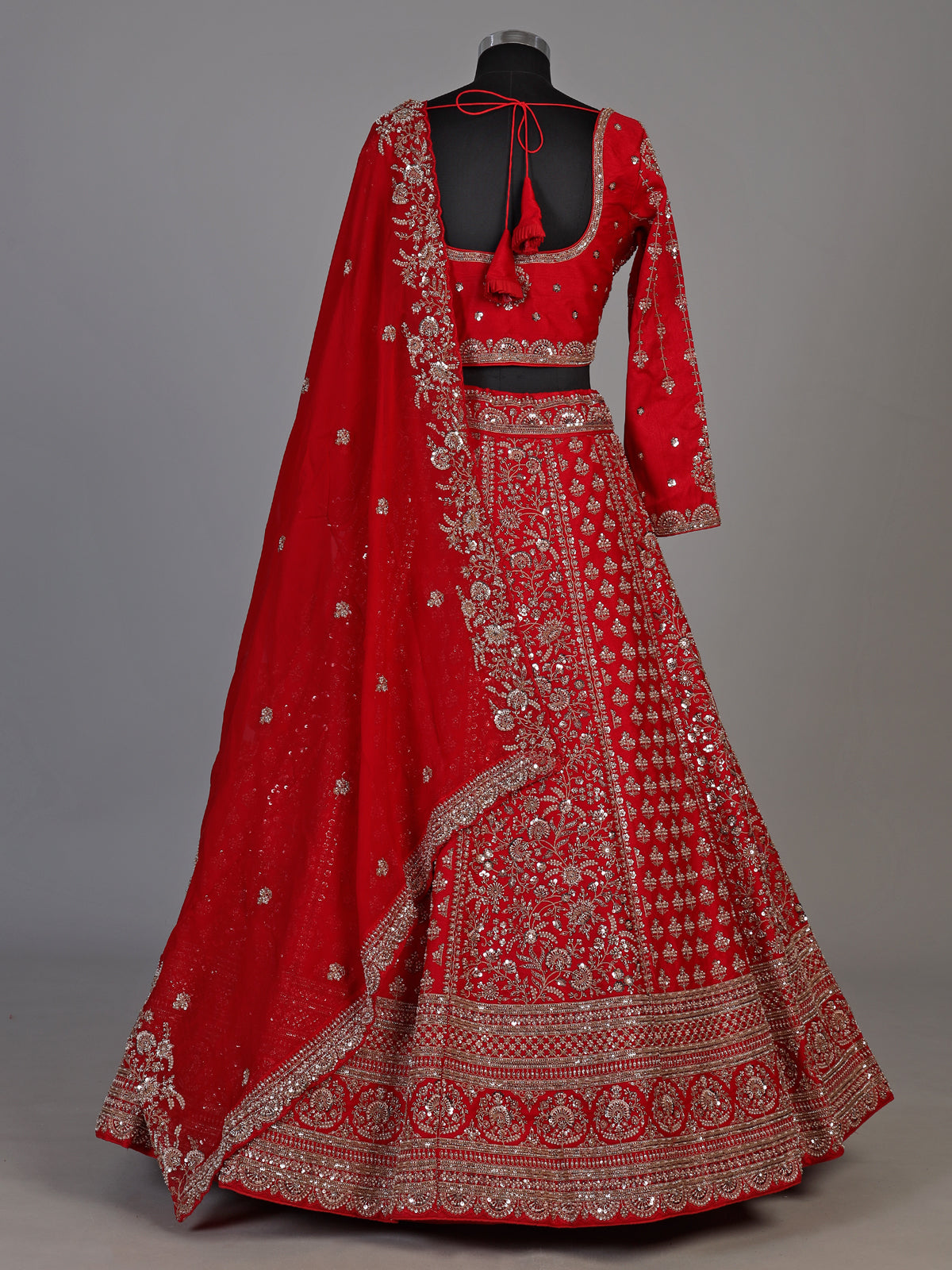 Red silk lehenga choli with exquisite resham and cutdana detailing