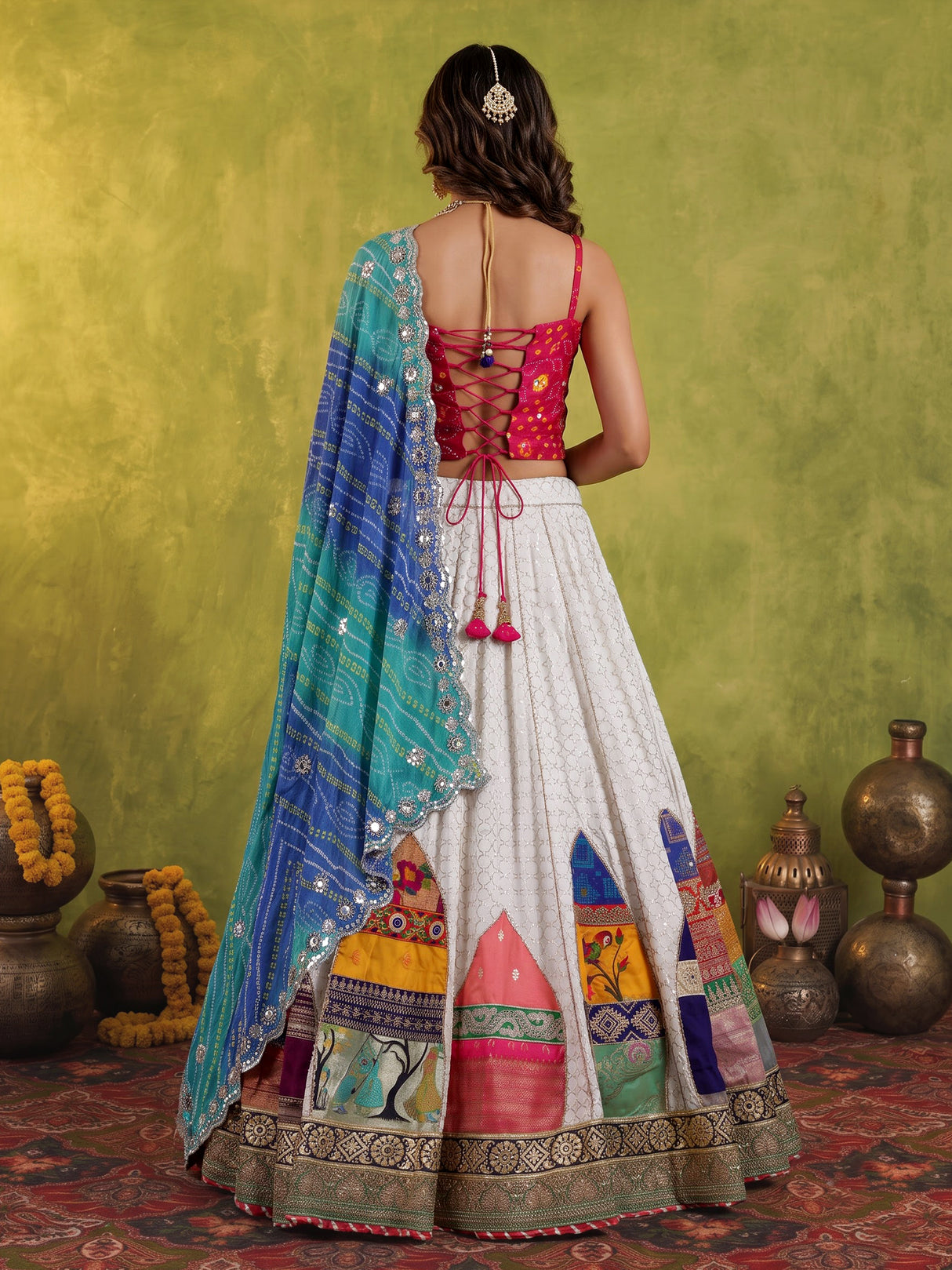 White silk blend lehenga choli with intricate traditional embellishments