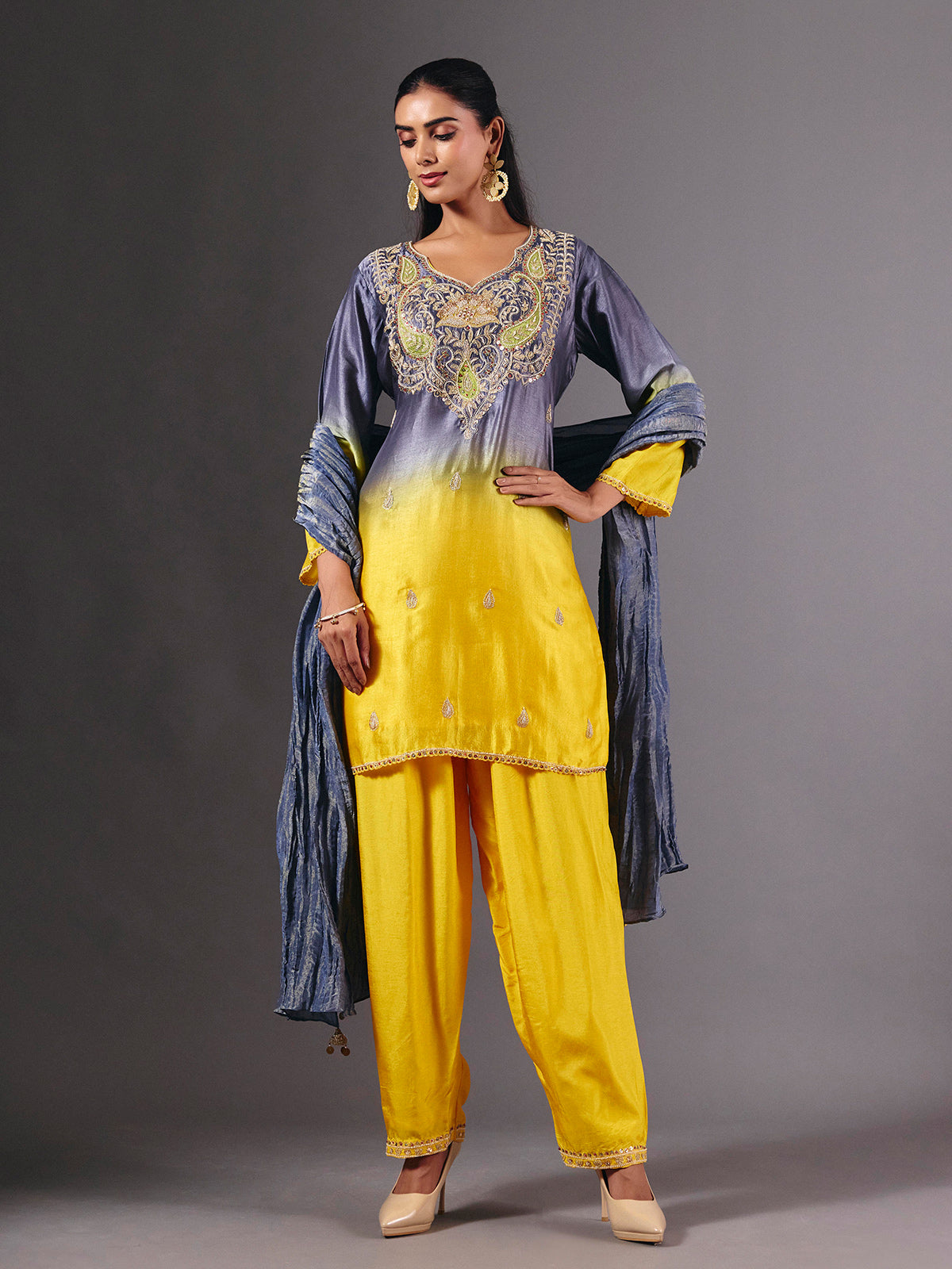 Yellow silk shaded salwar suit with purple dupatta and embellishments