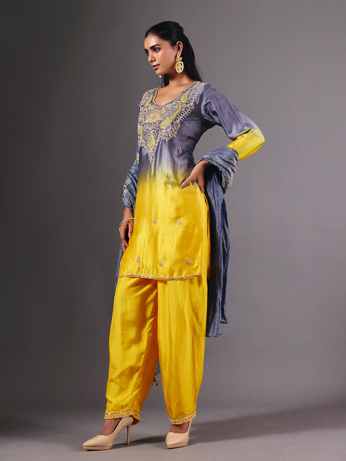 Yellow silk shaded salwar suit with purple dupatta and embellishments