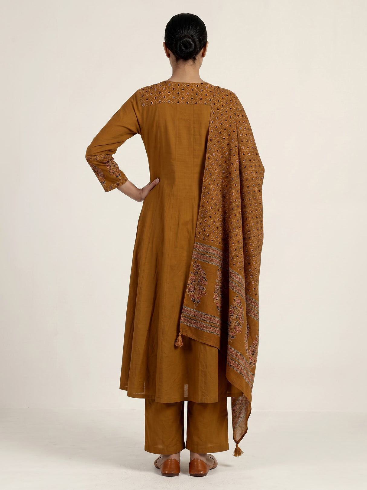 Mustard yellow cotton silk anarkali kurti set with tassel accents
