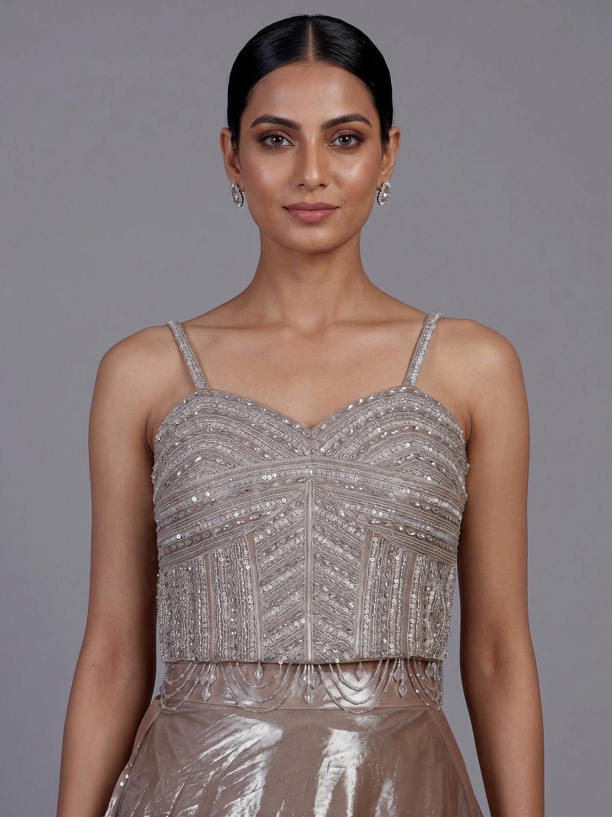 Sophisticated beige shimmer tissue silk lehenga choli with tassel accents
