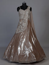 Sophisticated beige shimmer tissue silk lehenga choli with tassel accents