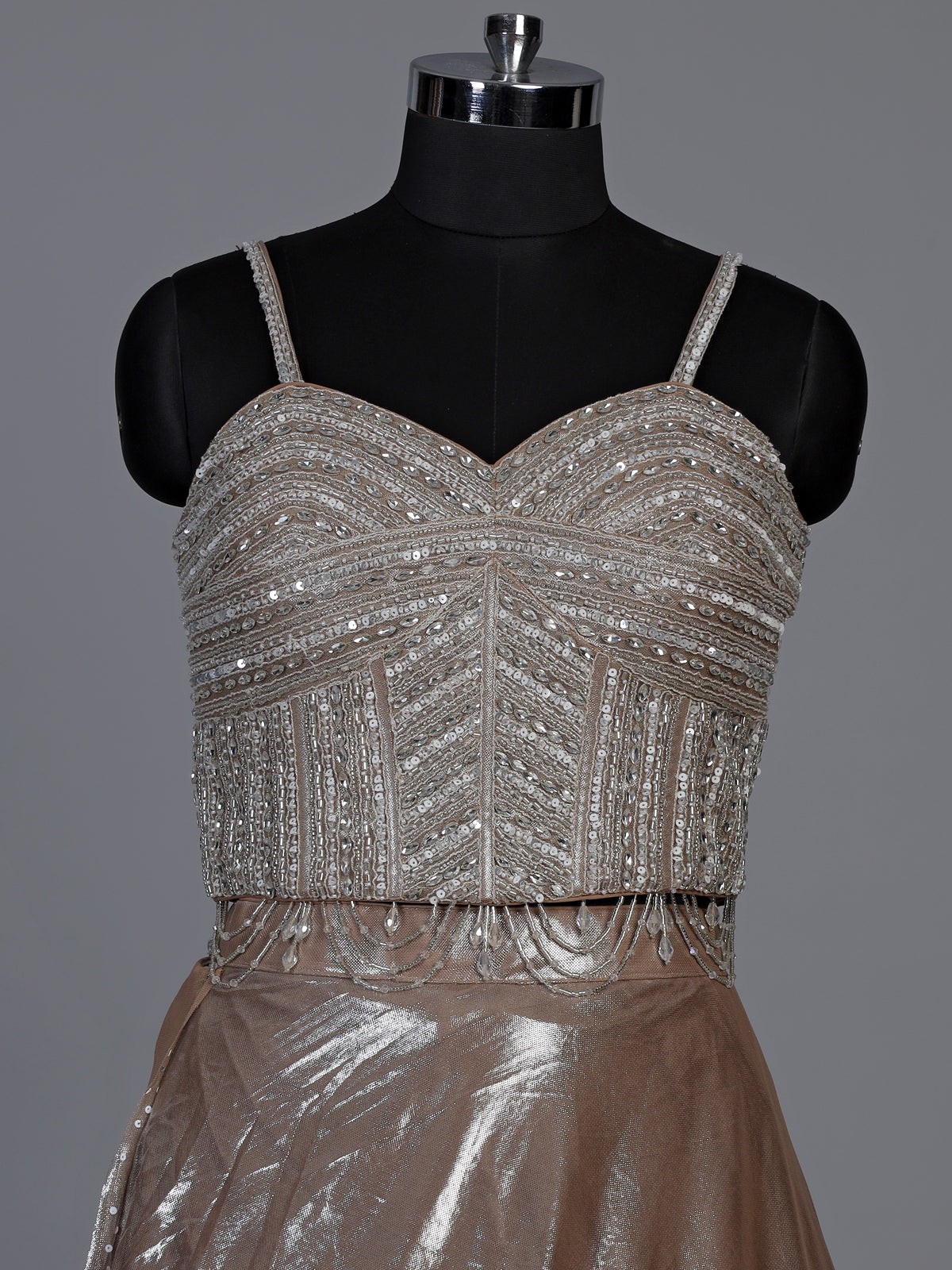 Sophisticated beige shimmer tissue silk lehenga choli with tassel accents