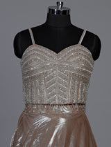 Sophisticated beige shimmer tissue silk lehenga choli with tassel accents