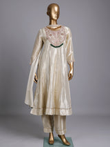Cream silk anarkali suit with dupatta and ornate embellishments