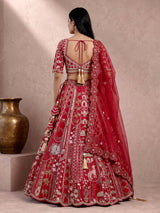 Maroon raw silk lehenga choli with artistic motifs and tassels