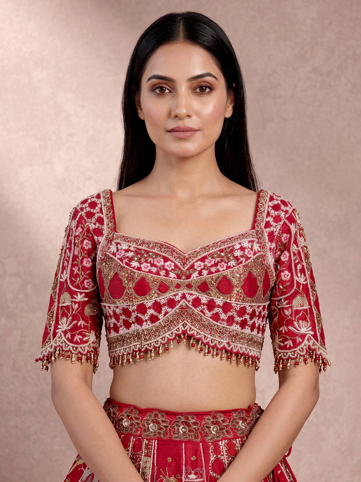 Maroon raw silk lehenga choli with artistic motifs and tassels