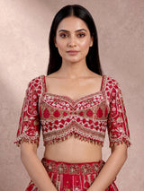 Maroon raw silk lehenga choli with artistic motifs and tassels