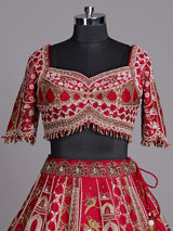 Maroon raw silk lehenga choli with artistic motifs and tassels