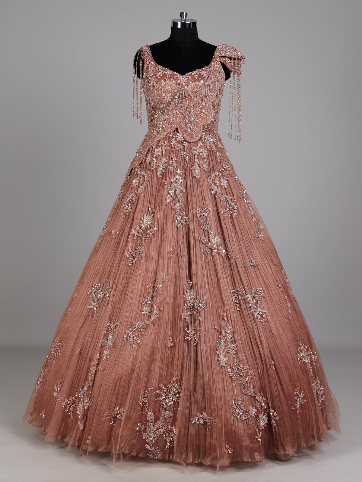 Dusty peach ball gown with floral embellishments and fringe