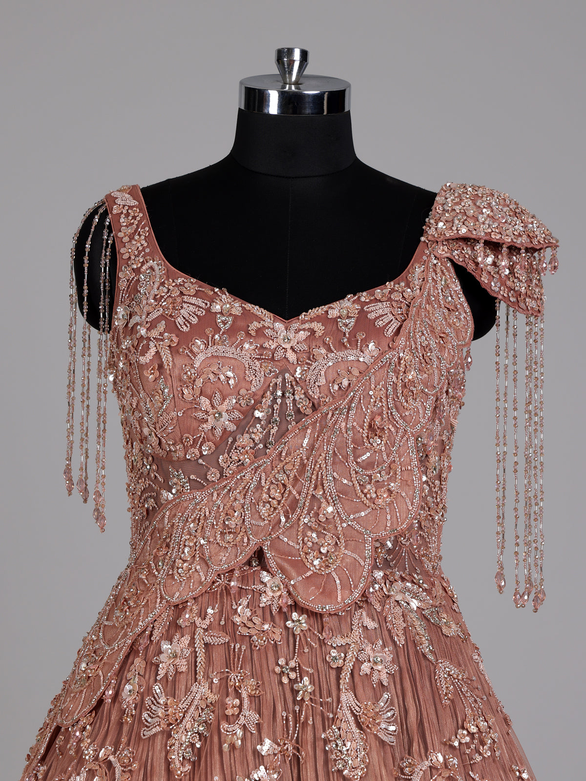 Dusty peach ball gown with floral embellishments and fringe