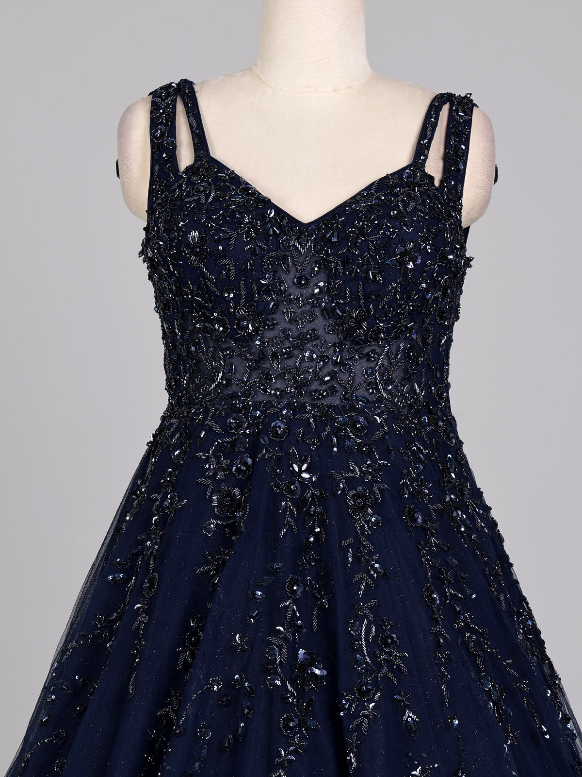 Midnight navy ball gown with embellished cape and flared skirt