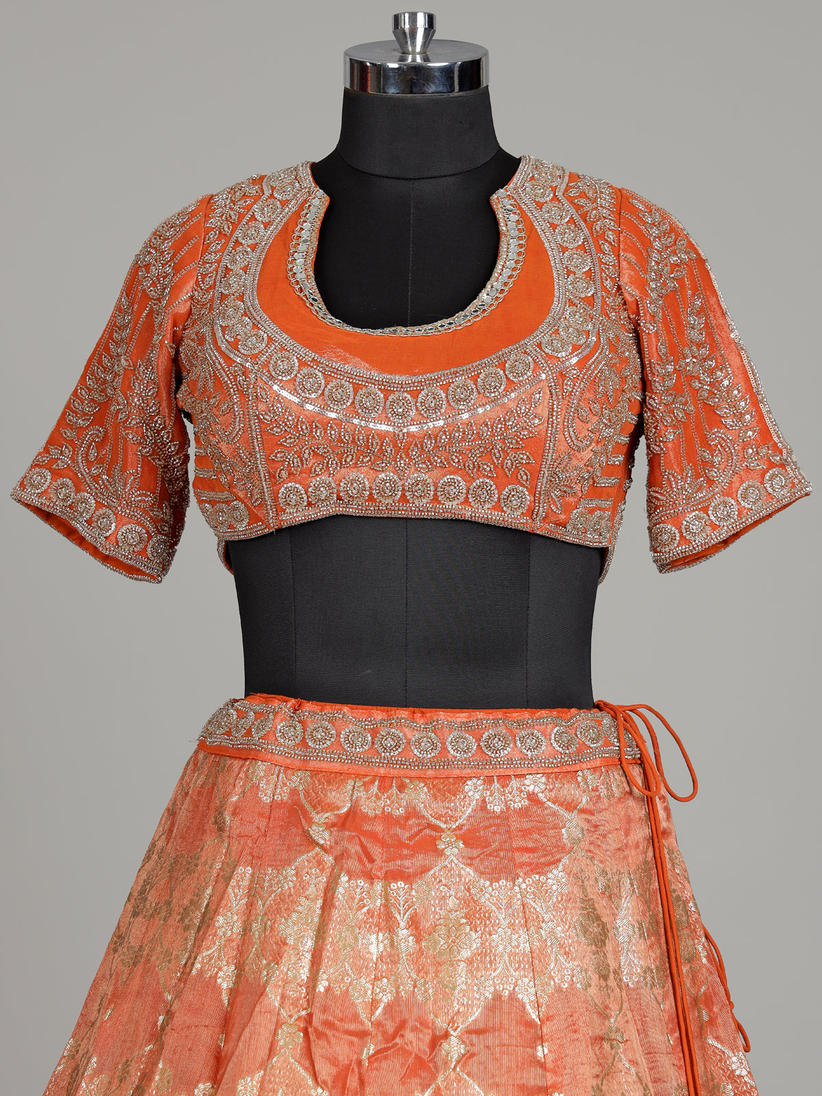 Rust orange banarasi silk lehenga choli with embellished dupatta