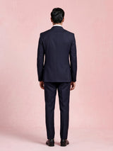 Midnight navy double-breasted tuxedo suit with metallic brooch
