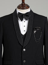 Jet black three-piece tuxedo suit with crystal brooch and cutdana