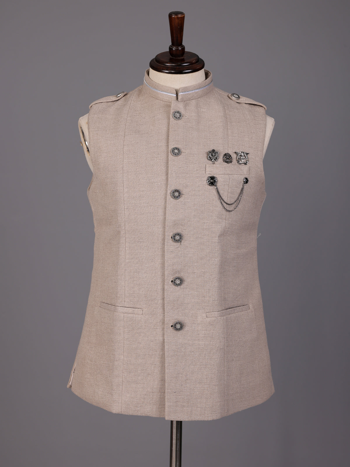 Beige textured waistcoat with metallic chain brooch detailing for mens