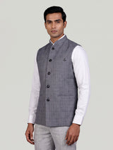 Grey micro-textured waistcoat with metallic brooch for mens weddings