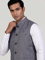 Grey micro-textured waistcoat with metallic brooch for mens weddings