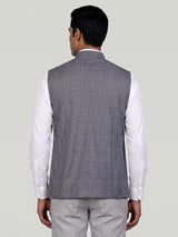 Grey micro-textured waistcoat with metallic brooch for mens weddings
