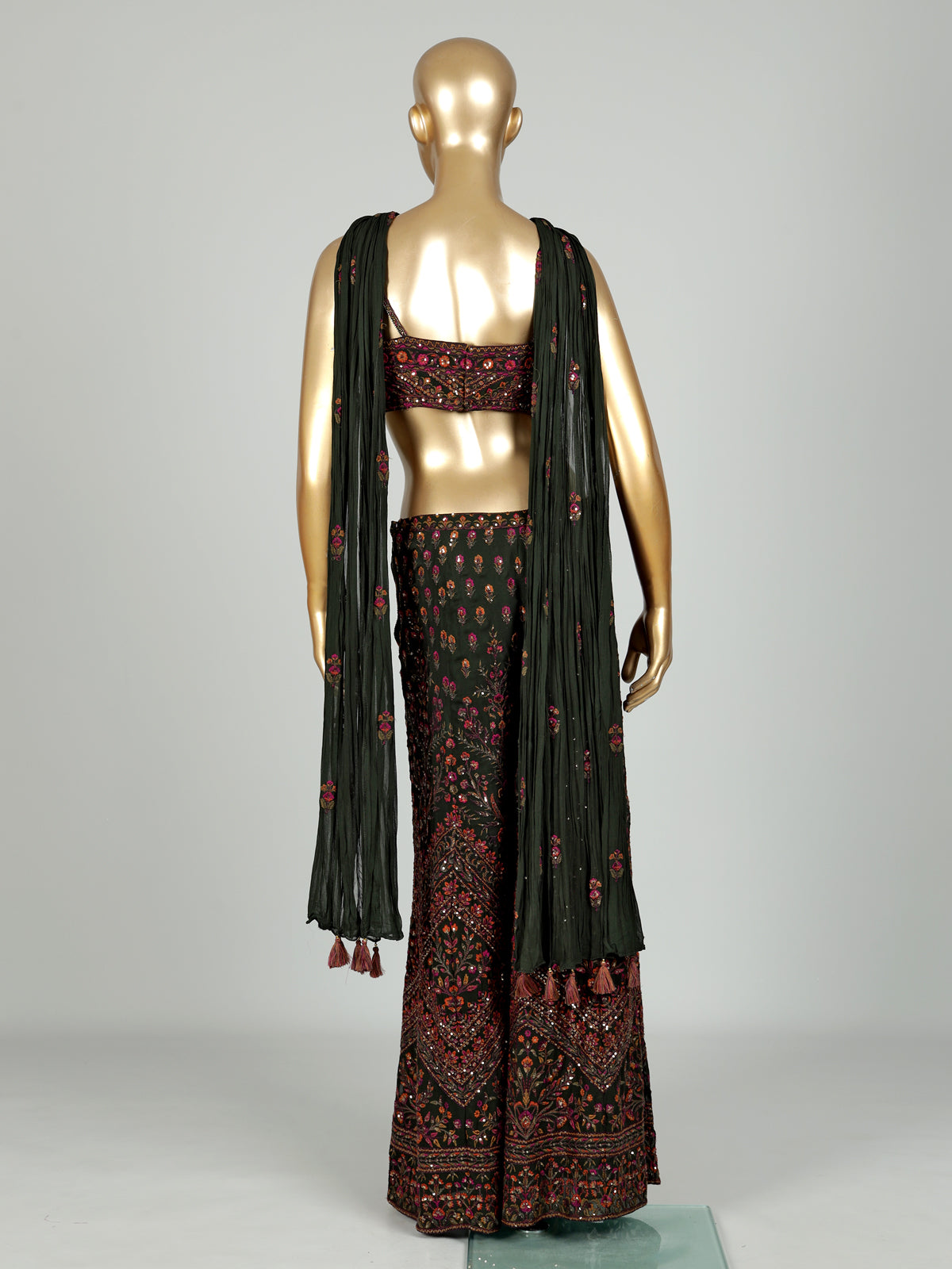 Dark mehendi green georgette palazzo suit with heavy festive embellishments