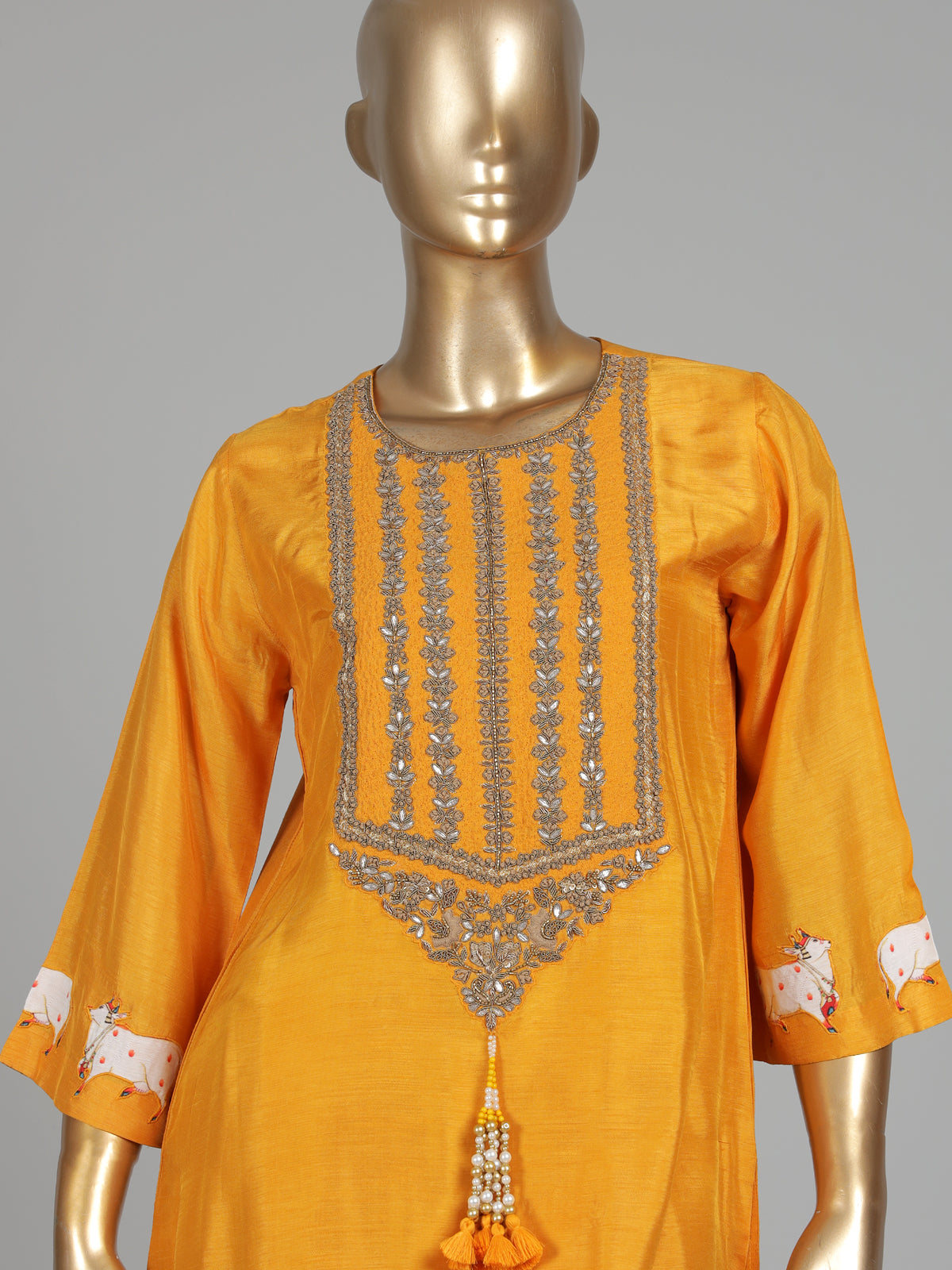 Mustard yellow silk sharara suit with animal motifs and gota work