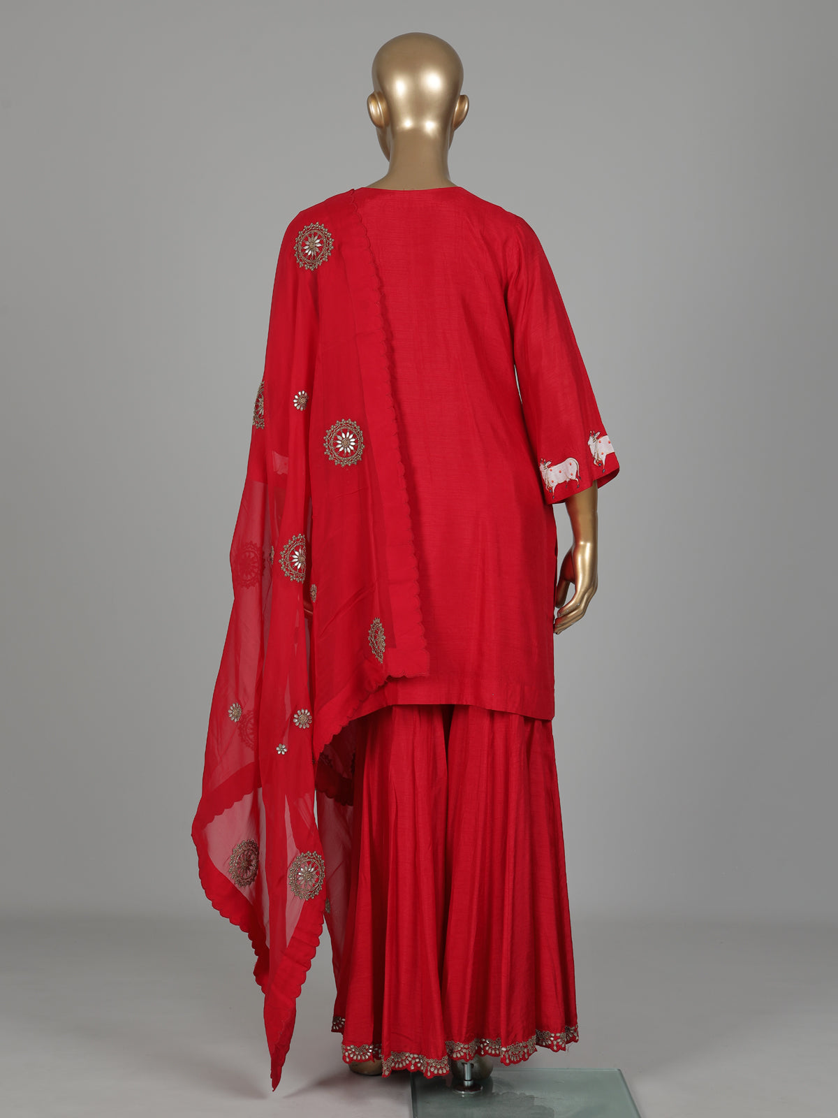 Red silk sharara suit with animal motifs, zardosi and gota detailing
