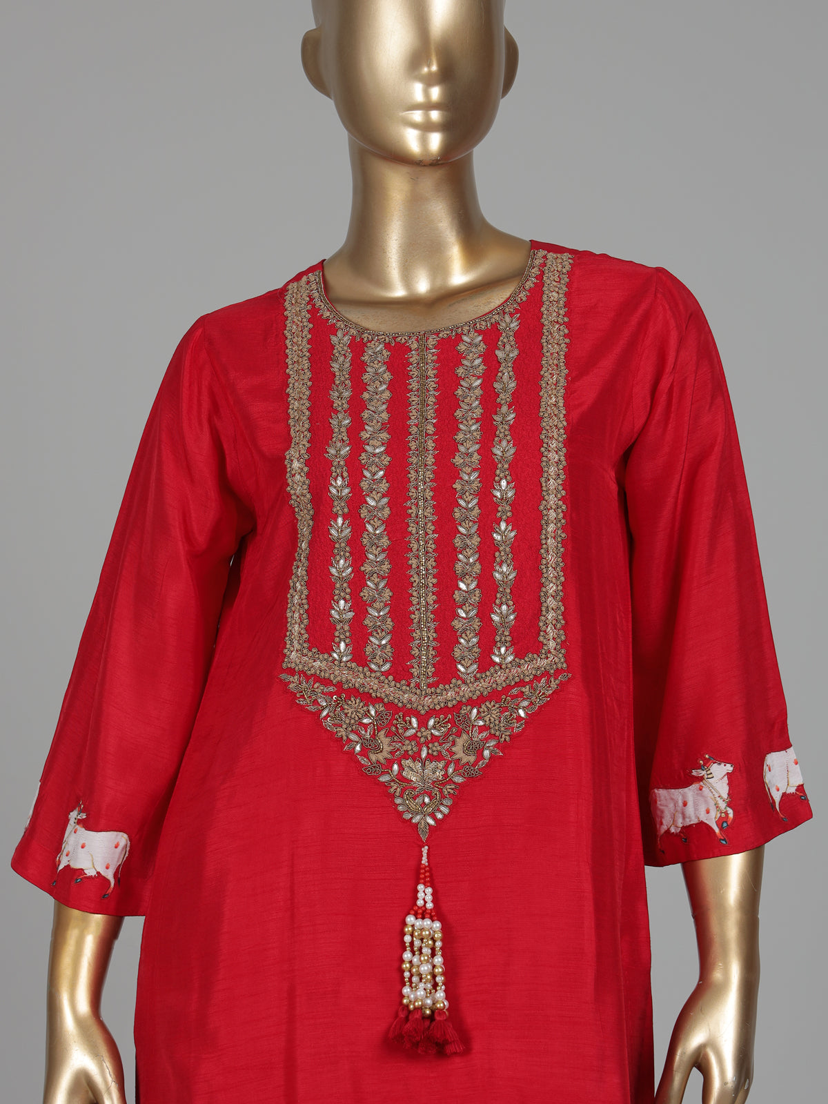 Red silk sharara suit with animal motifs, zardosi and gota detailing