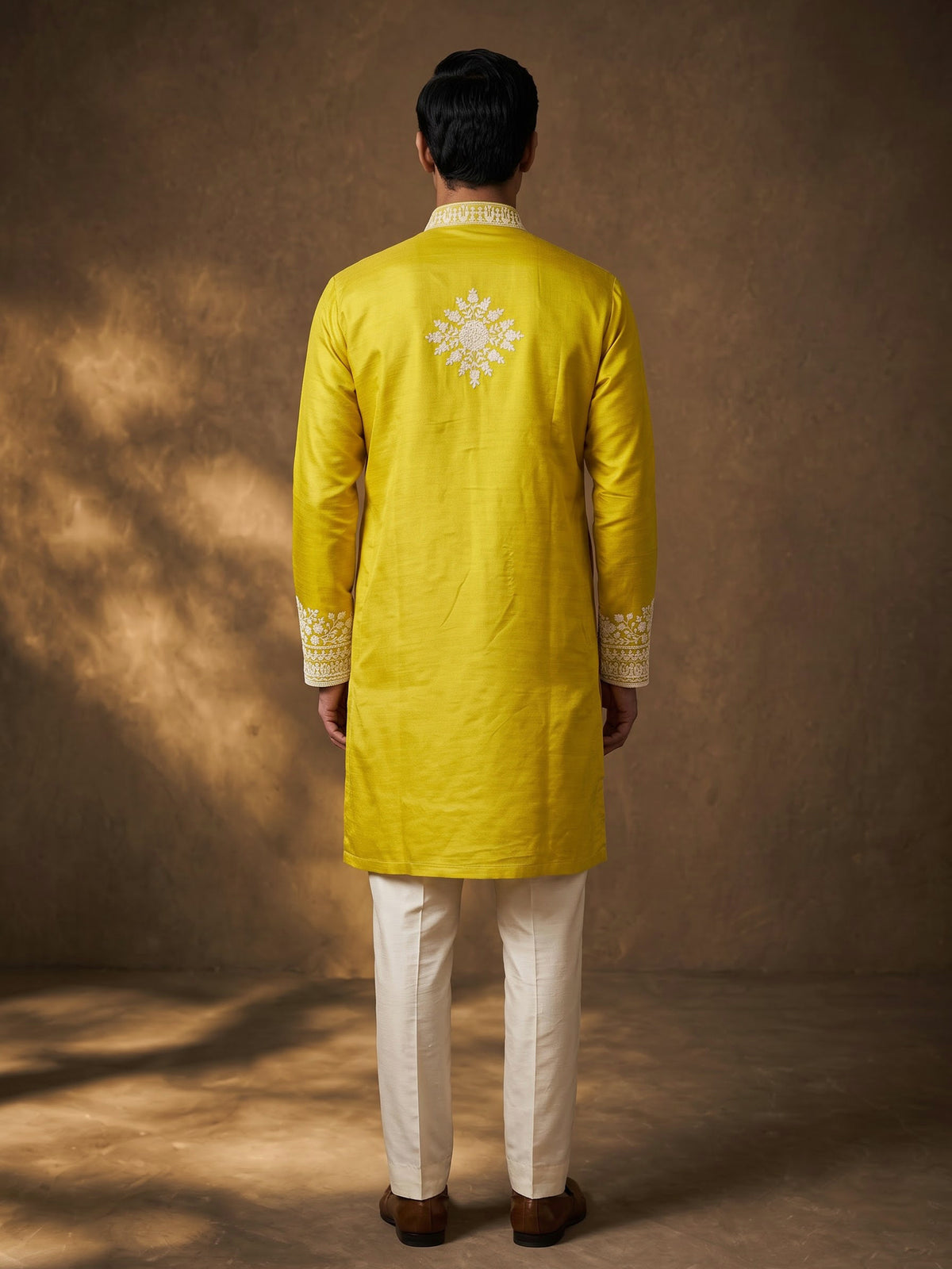 Mustard yellow silk kurta suit with ornate embellished yoke