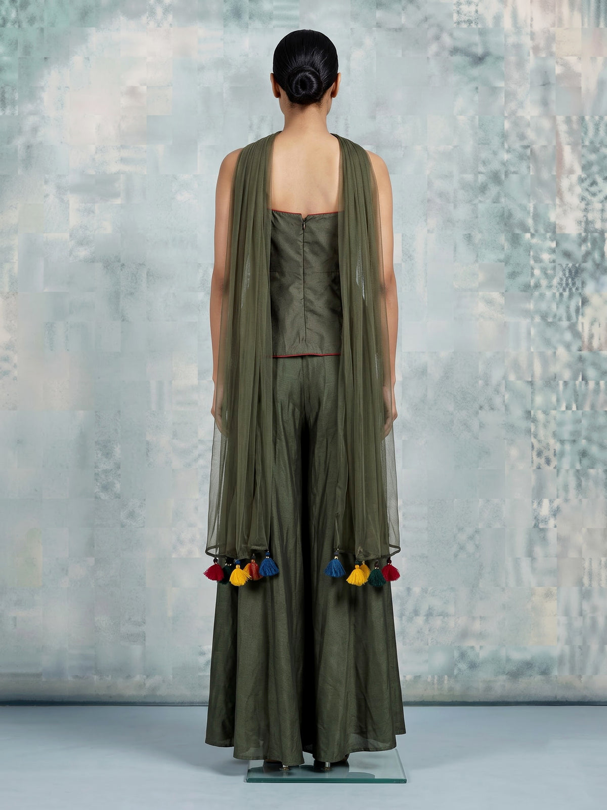 Mehendi green silk designer palazzo suit with festive tassel embellishments