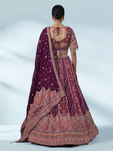 Purple silk lehenga choli with chevron panels and embellished drape