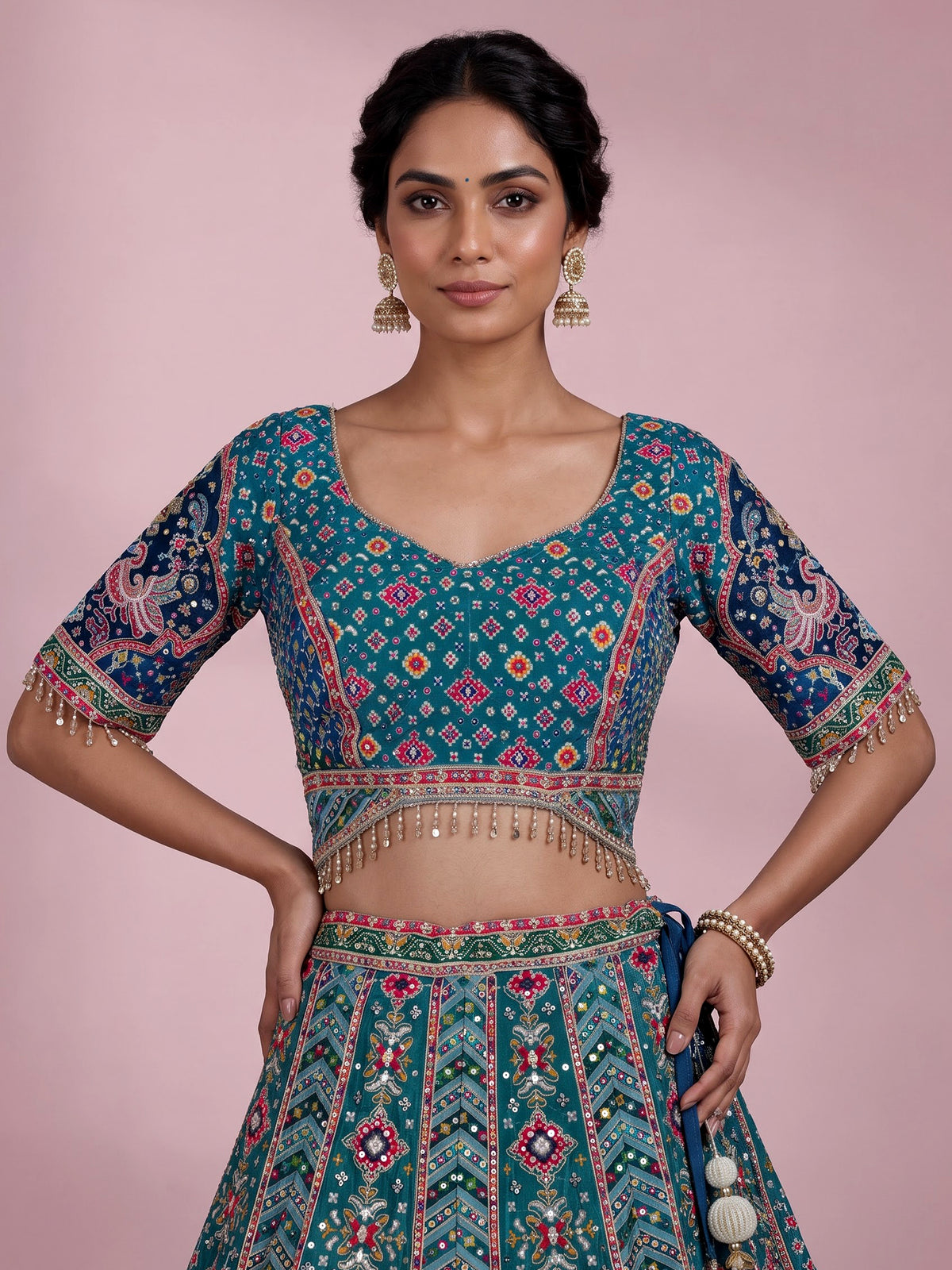 Rama green silk lehenga choli with bandhani patola detailing