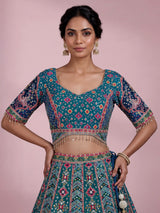 Rama green silk lehenga choli with bandhani patola detailing
