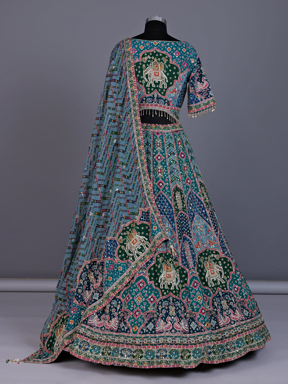 Rama green silk lehenga choli with bandhani patola detailing