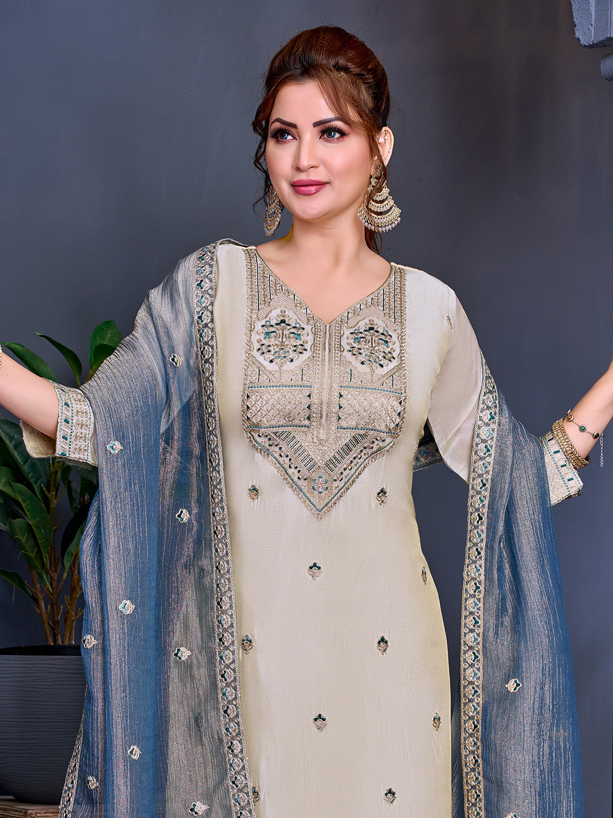Cream shimmer salwar suit with blue contrast dupatta and embroidered yoke