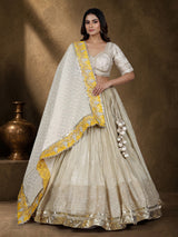 Beige silk lehenga choli with traditional aabla and gota work