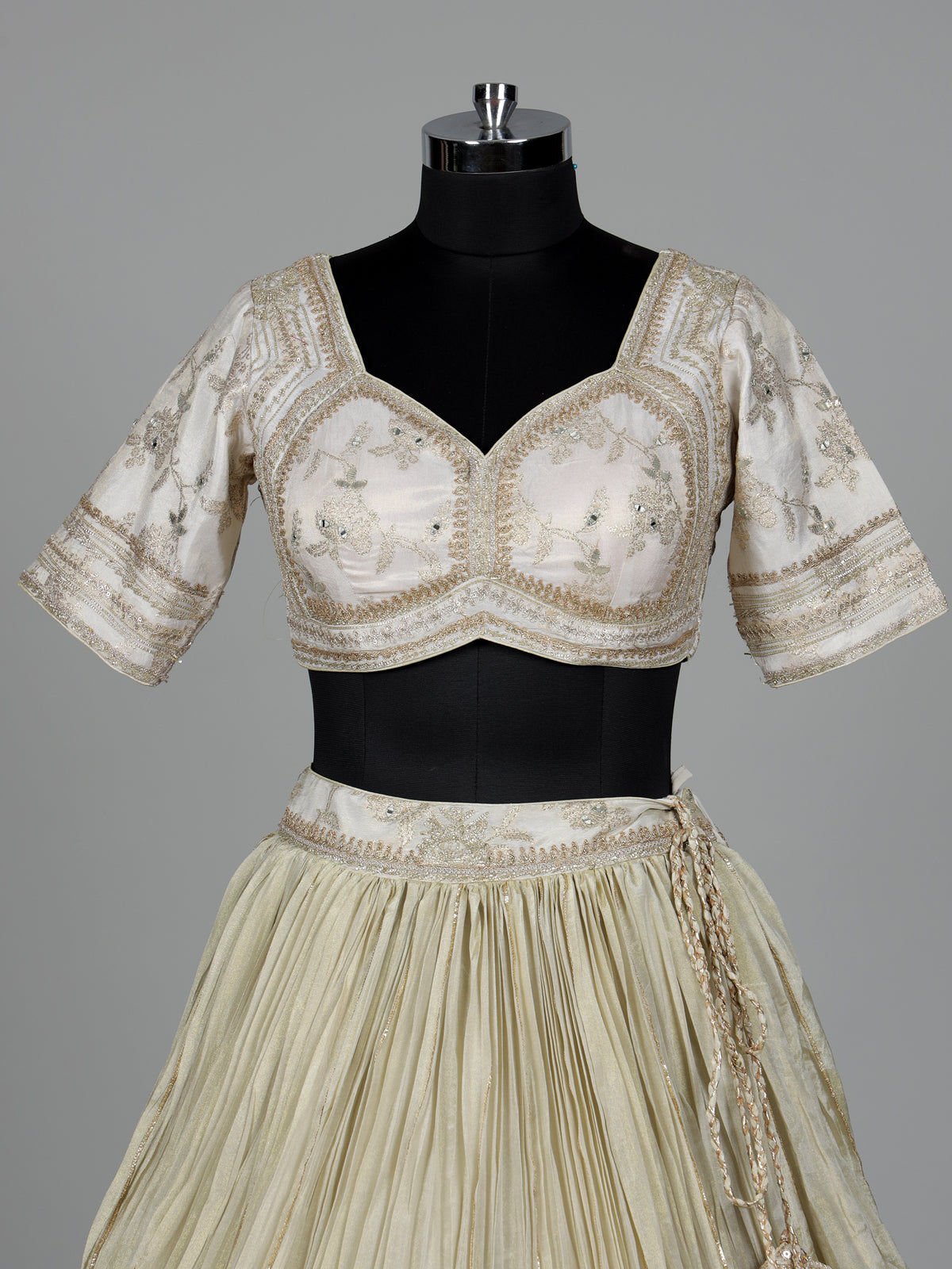Beige silk lehenga choli with traditional aabla and gota work