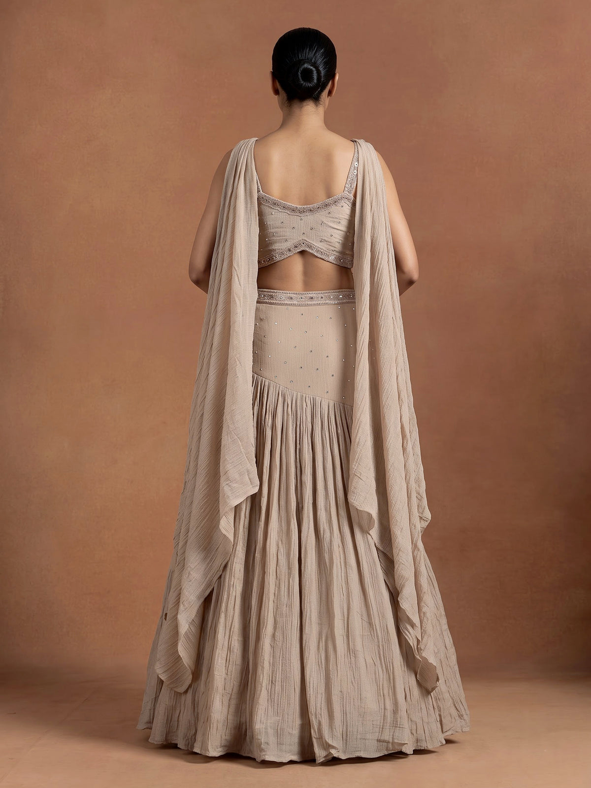 Beige chiffon silk lehenga choli with diamond and tassel detailing