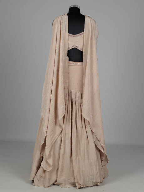 Beige chiffon silk lehenga choli with diamond and tassel detailing