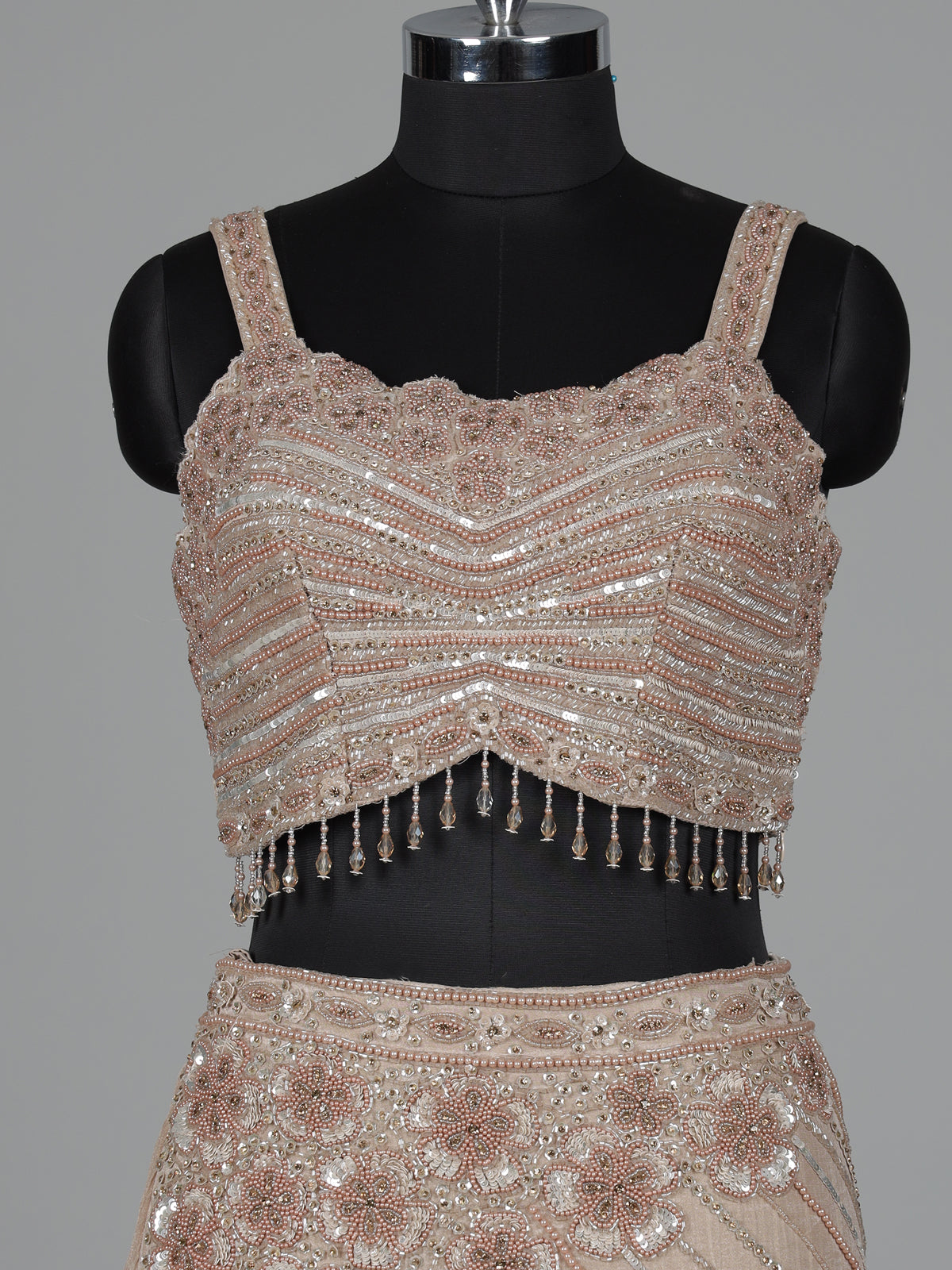 Beige chiffon silk lehenga choli with diamond and tassel detailing