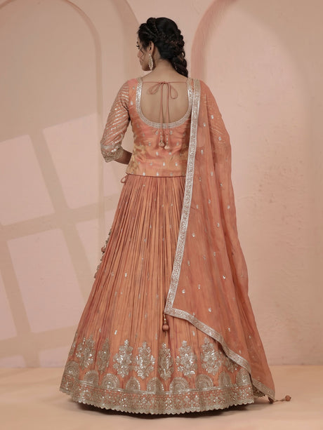 Pastel peach silk lehenga choli with elegant zardosi embroidery