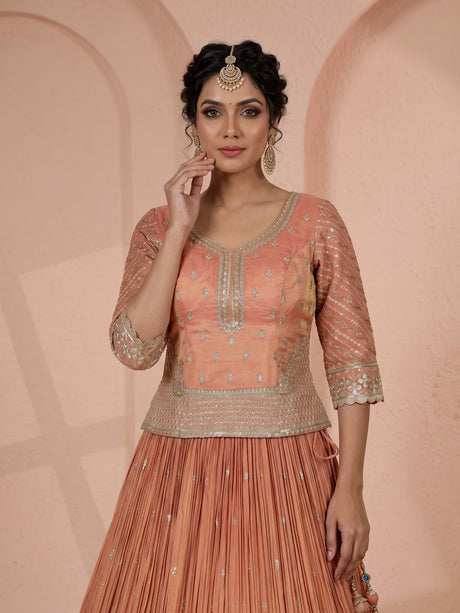 Pastel peach silk lehenga choli with elegant zardosi embroidery