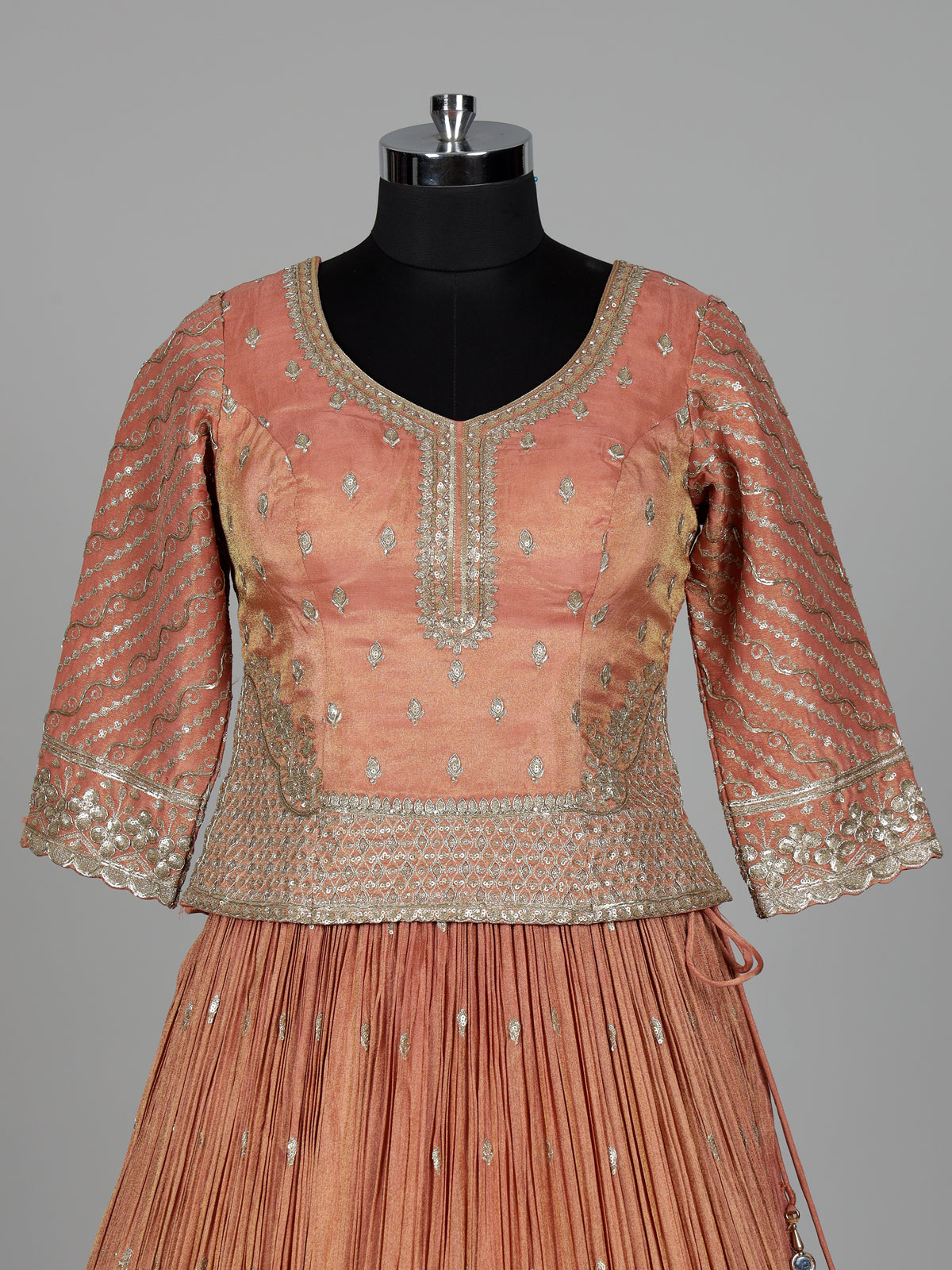 Pastel peach silk lehenga choli with elegant zardosi embroidery