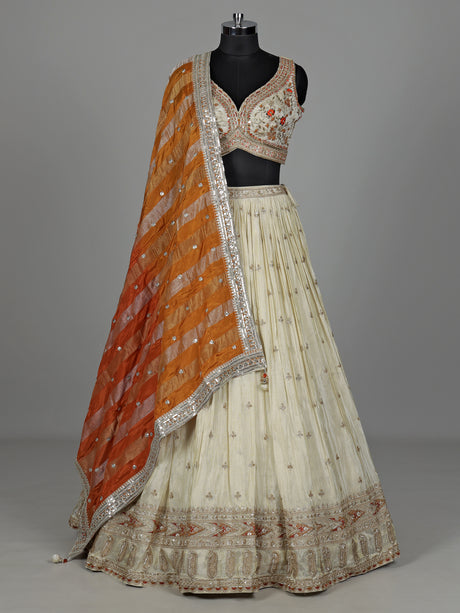 Beige silk lehenga choli with mirror work and contrast dupatta