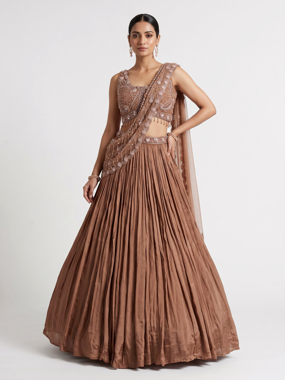 Beige chiffon silk lehenga choli with diamond and tassel accents