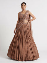 Beige chiffon silk lehenga choli with diamond and tassel accents