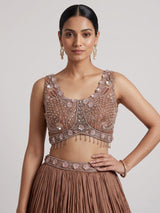 Beige chiffon silk lehenga choli with diamond and tassel accents