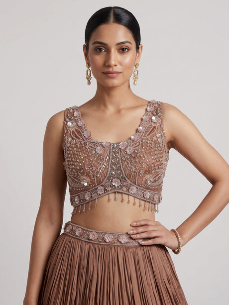 Beige chiffon silk lehenga choli with diamond and tassel accents