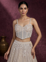 Beige net designer lehenga choli with heavy embellished cape shrug