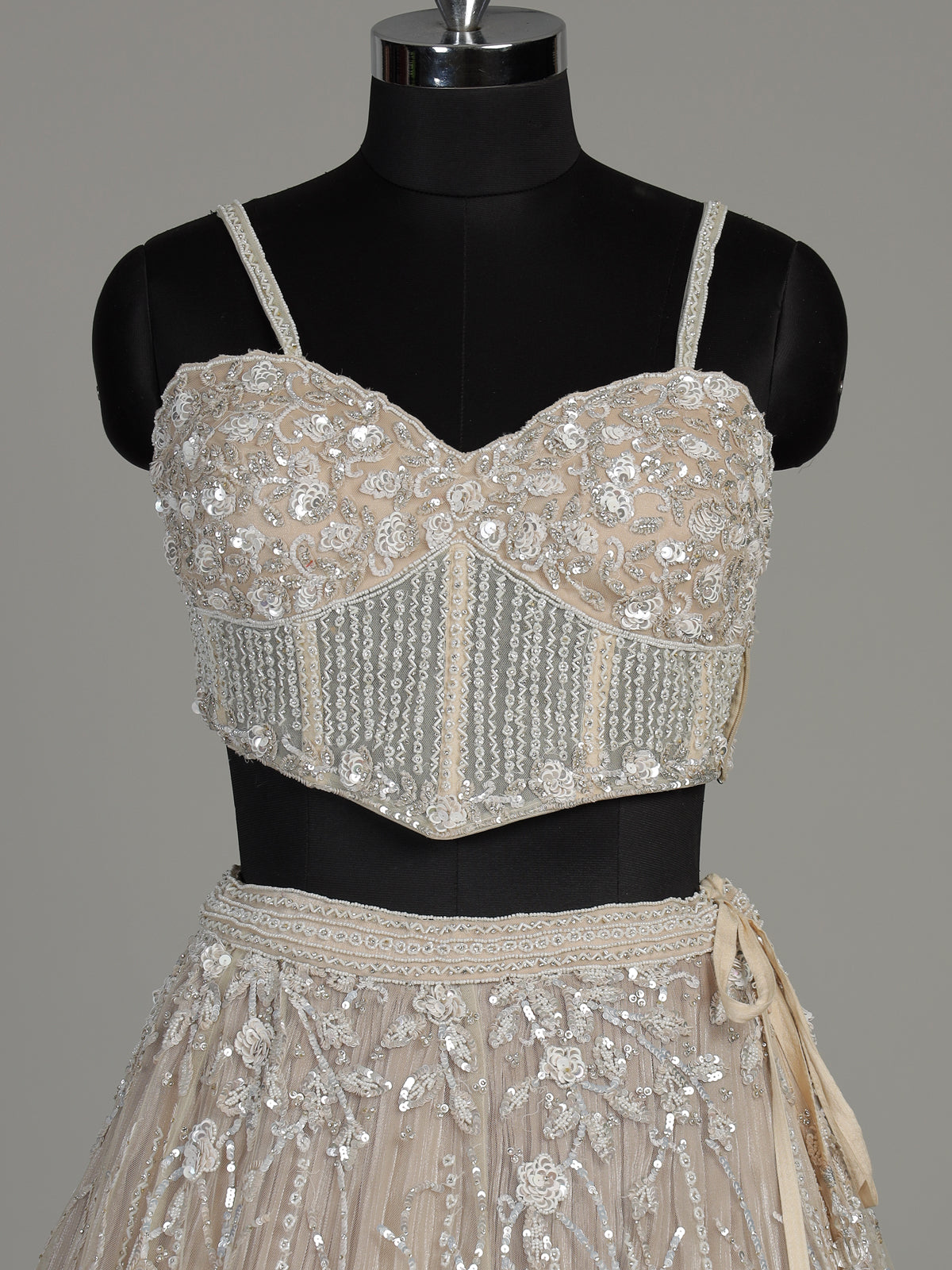 Beige net designer lehenga choli with heavy embellished cape shrug